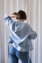 Load image into Gallery viewer, Novels Simple Wrap Jacket (Finnish PDF) | The Simple Wrap Jacket is your go-to top for home office and after works. It works as a top or a light jacker depending on the fabric you choose, and you can wear the jacket loose or snug. The jacket is a wrap design with a detachable belt. The wide cuffs and front piece are finished with decorative stitching.