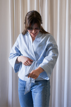 Load image into Gallery viewer, Novels Simple Wrap Jacket (Finnish PDF) | The Simple Wrap Jacket is your go-to top for home office and after works. It works as a top or a light jacker depending on the fabric you choose, and you can wear the jacket loose or snug. The jacket is a wrap design with a detachable belt. The wide cuffs and front piece are finished with decorative stitching.