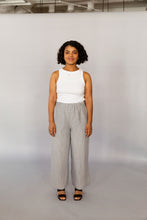 Load image into Gallery viewer, Novels Pull-On Pants feature a high waist, elastic waistband and side pockets. The fit is relaxed and slightly cropped. The pants are a true wardrobe staple for easy everyday. This is a digital product that includes pattern and sewing instructions in Finnish in PDF format.