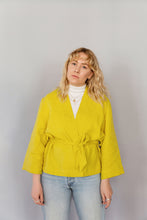 Load image into Gallery viewer, Novels Simple Wrap Jacket (Finnish PDF) | The Simple Wrap Jacket is your go-to top for home office and after works. It works as a top or a light jacker depending on the fabric you choose, and you can wear the jacket loose or snug. The jacket is a wrap design with a detachable belt. The wide cuffs and front piece are finished with decorative stitching.